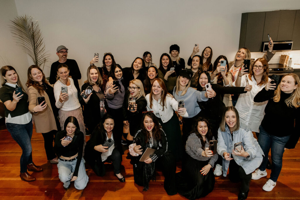 christine coughlin with a large group of female entrepreneurs and content creators smiles at the camera